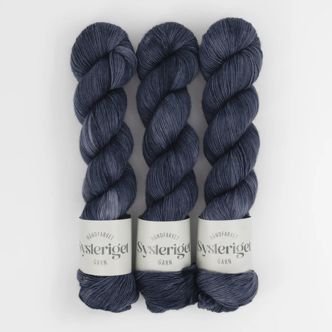 Sysleriget hand dyed yarn in single ply merino wool in the color Storm Blue.